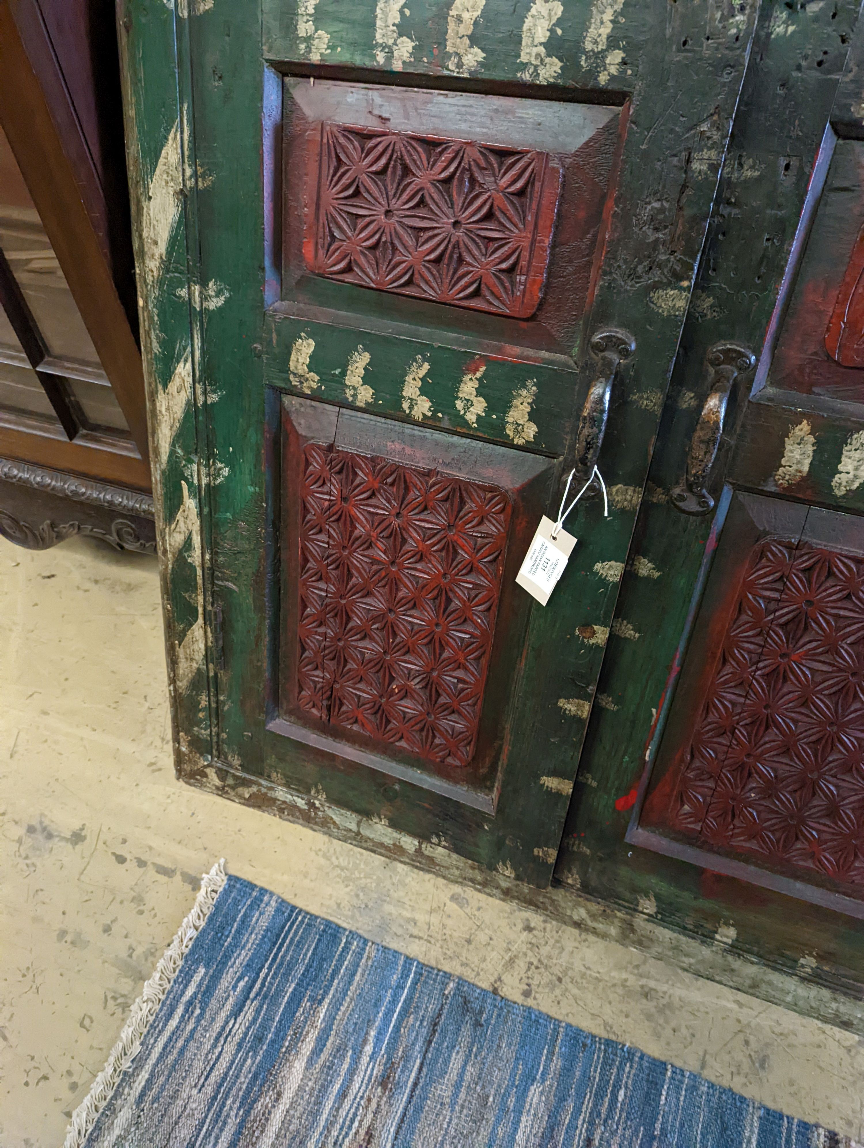 An Indian painted carved hardwood corner cupboard, width 90cm, height 131cm